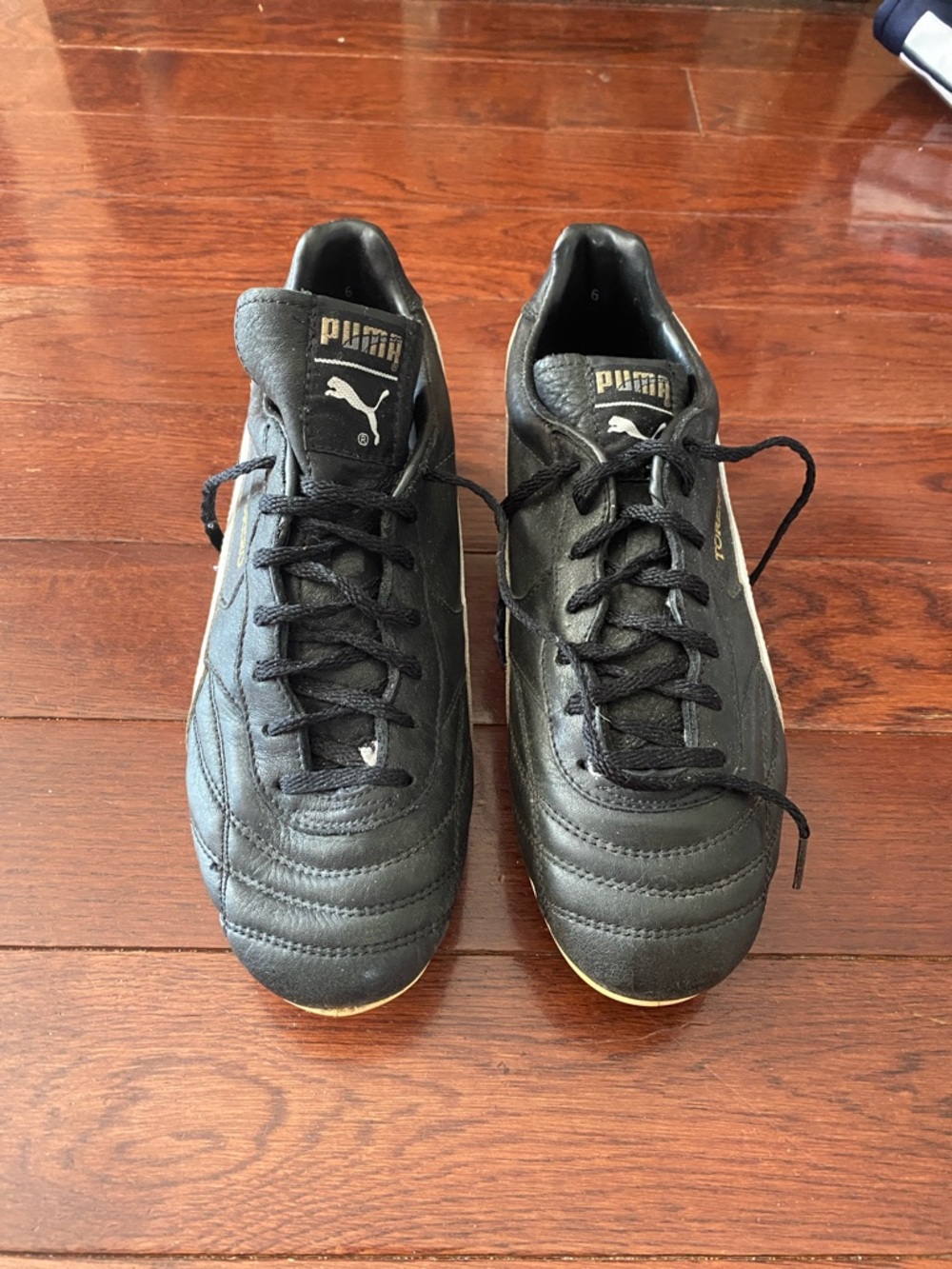 Puma Men’s Black and Gold Athletic Soccer Shoes